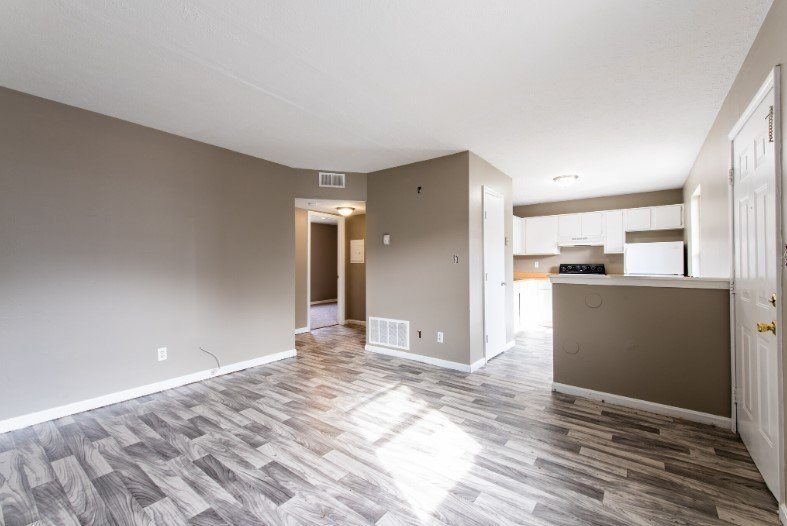 A room with a wooden floor and a white ceiling.